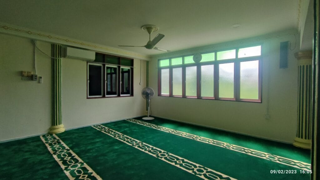 Kemasan lantai karpet masjid hijau bercorak saf klasik berhampiran barisan tingkap di Masjid Jamek Seri Pangkalan